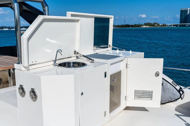 Greyt Escape Yacht Photos Pics Outdoor kitchen on 2013 Astondoa 72 GLX yacht with sink and storage, overlooking water.