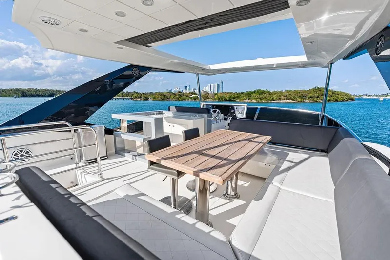 Greyt Escape Yacht Photos Pics Luxurious 2013 Astondoa 72 GLX yacht deck with seating and dining area, overlooking serene waters.