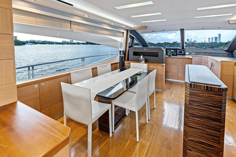 Greyt Escape Yacht Photos Pics Luxurious interior of 2013 Astondoa 72 GLX yacht with modern dining area and scenic water view.