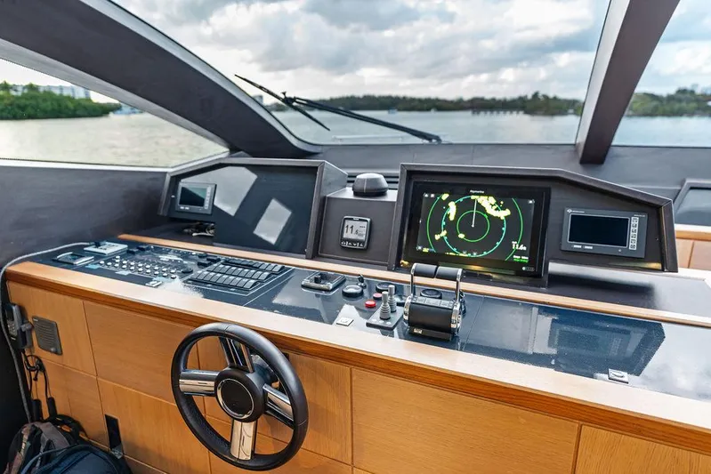 Greyt Escape Yacht Photos Pics Helm of 2013 Astondoa 72 GLX yacht with navigation screens and steering wheel.