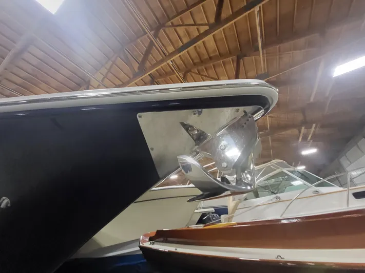  Yacht Photos Pics 2022 Fountain 38 SC boat in indoor storage, showcasing sleek bow design.