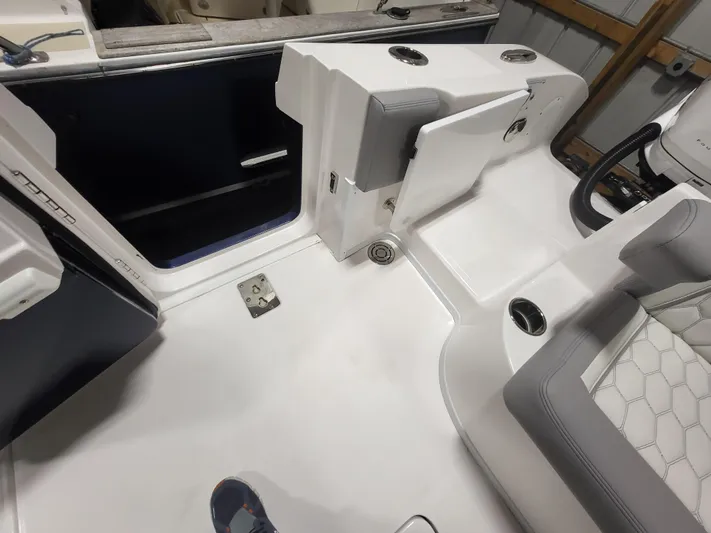  Yacht Photos Pics 2022 Fountain 38 SC boat interior with white seating and storage compartments.