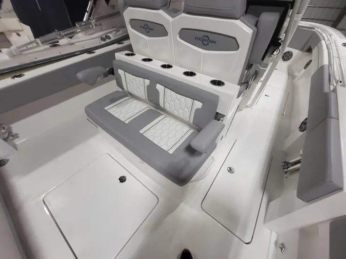  Yacht Photos Pics 2022 Fountain 38 SC boat interior with gray and white seating and cup holders.