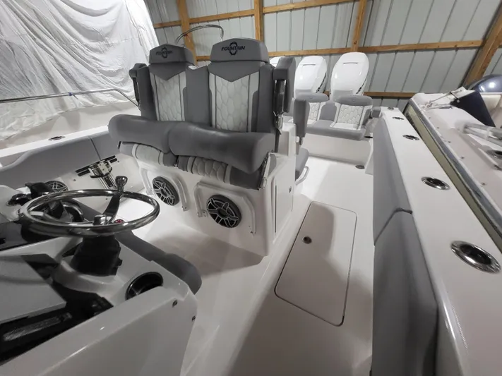  Yacht Photos Pics 2022 Fountain 38 SC boat interior with modern seating and steering wheel.