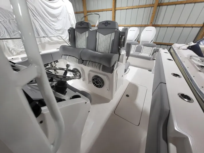  Yacht Photos Pics 2022 Fountain 38 SC boat interior with modern seating and steering wheel.