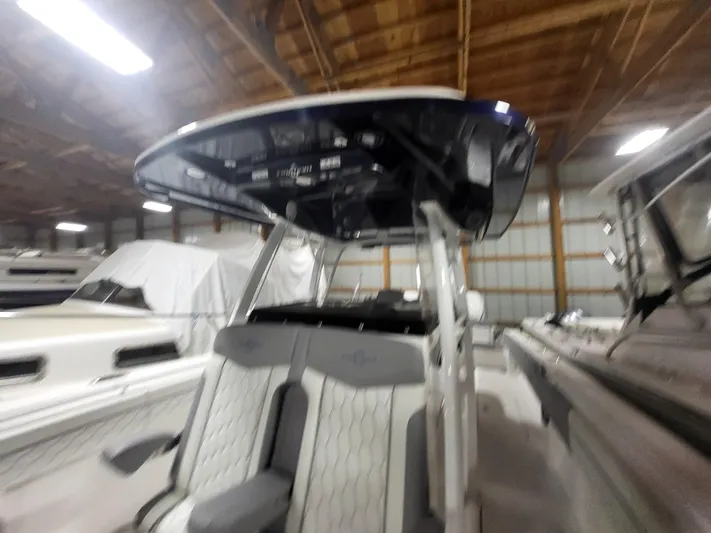  Yacht Photos Pics 2022 Fountain 38 SC boat interior with seating and console in a storage facility.