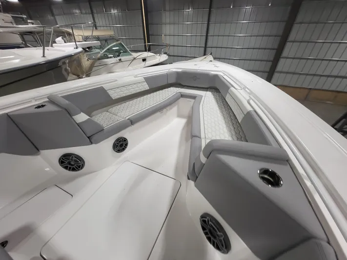  Yacht Photos Pics 2022 Fountain 38 SC boat interior with gray seating and speakers in a storage facility.