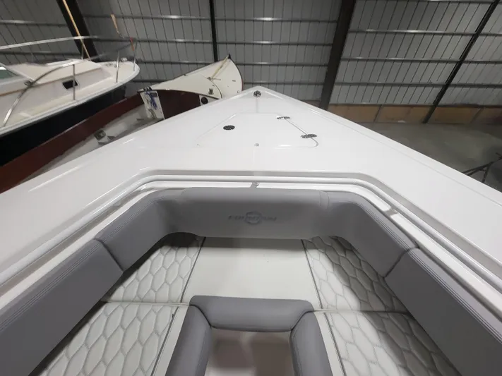  Yacht Photos Pics 2022 Fountain 38 SC boat interior with sleek seating in a storage facility.