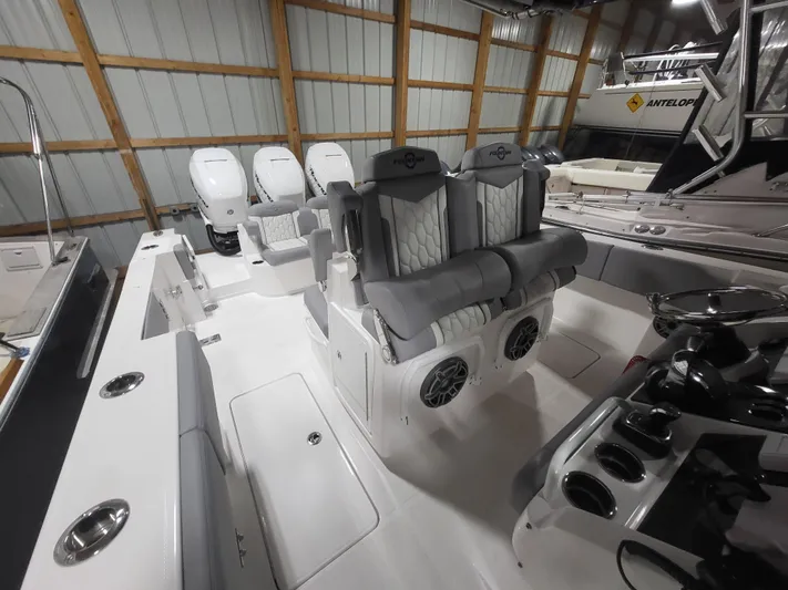  Yacht Photos Pics 2022 Fountain 38 SC boat interior with plush seating and modern controls in a storage facility.