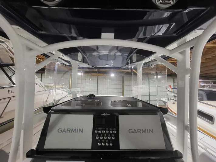  Yacht Photos Pics 2022 Fountain 38 SC boat cockpit with dual Garmin displays in a showroom.