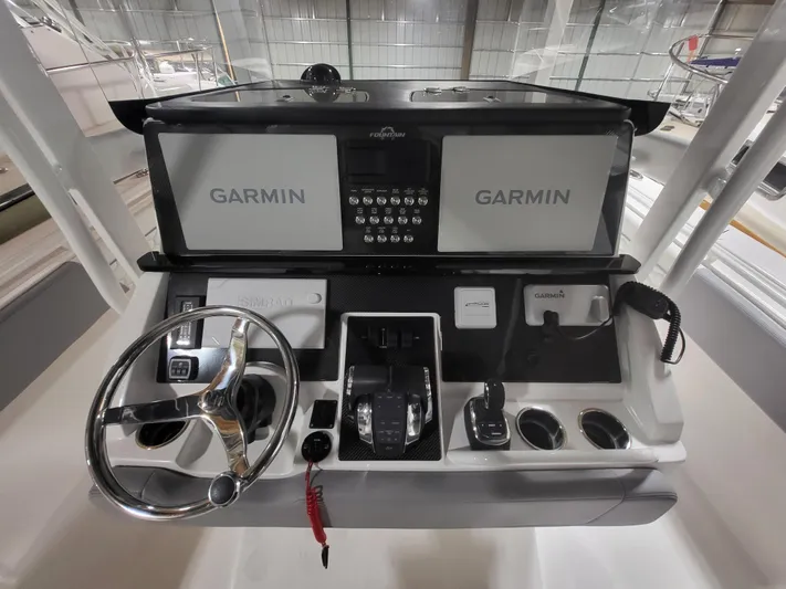  Yacht Photos Pics 2022 Fountain 38 SC boat dashboard with dual Garmin displays and steering wheel.