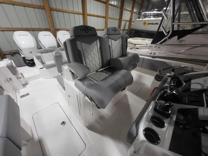  Yacht Photos Pics 2022 Fountain 38 SC boat interior with luxurious seating and modern controls.