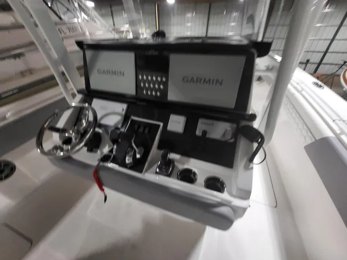  Yacht Photos Pics 2022 Fountain 38 SC boat dashboard with dual Garmin displays and steering wheel.