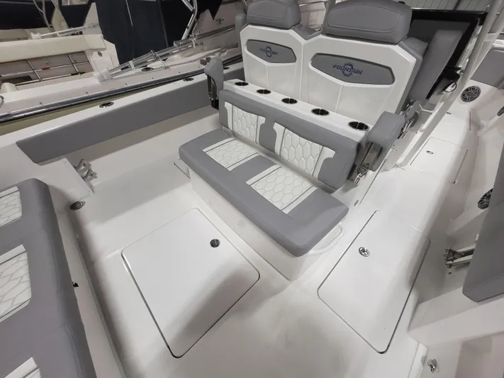  Yacht Photos Pics 2022 Fountain 38 SC boat interior with gray and white seating and cup holders.