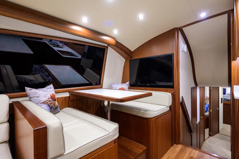  Yacht Photos Pics Luxurious interior of 2022 F&S 58 Custom Carolina yacht with elegant seating and wood finishes.