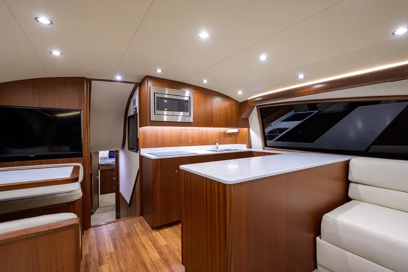  Yacht Photos Pics Luxurious interior of 2022 F&S 58 Custom Carolina yacht with modern kitchen and seating area.