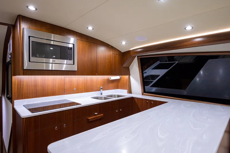  Yacht Photos Pics Luxurious kitchen interior of 2022 F&S 58 Custom Carolina yacht with modern appliances.