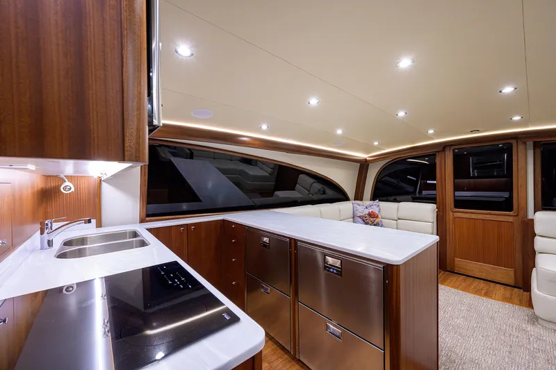  Yacht Photos Pics Luxurious interior of 2022 F&S 58 Custom Carolina yacht with modern kitchen and seating area.