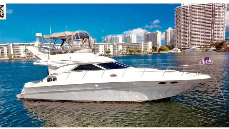  Yacht Photos Pics 1998 Sea Ray 400 Sedan Bridge yacht on water with city skyline background.