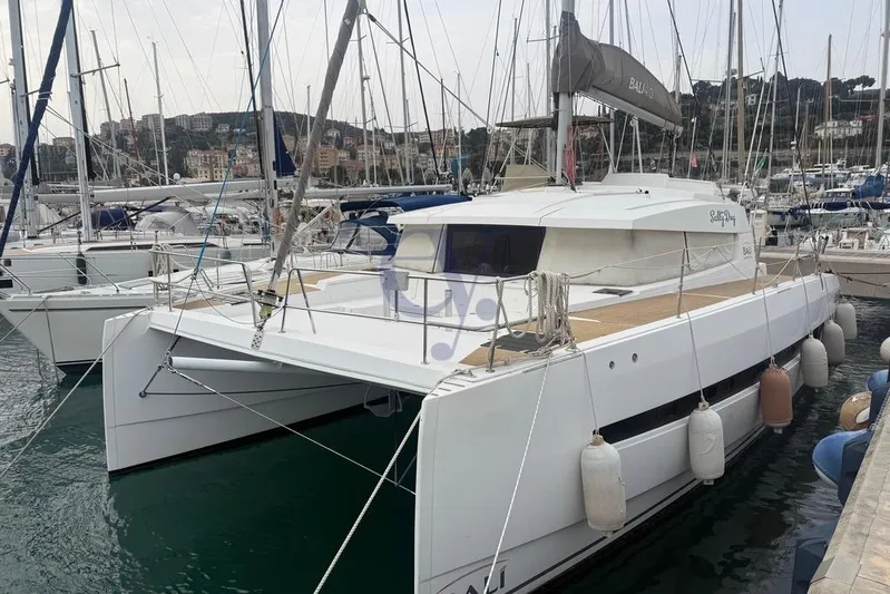  Yacht Photos Pics 2016 Catana Group Bali 4.0 catamaran docked in a marina, surrounded by other boats.