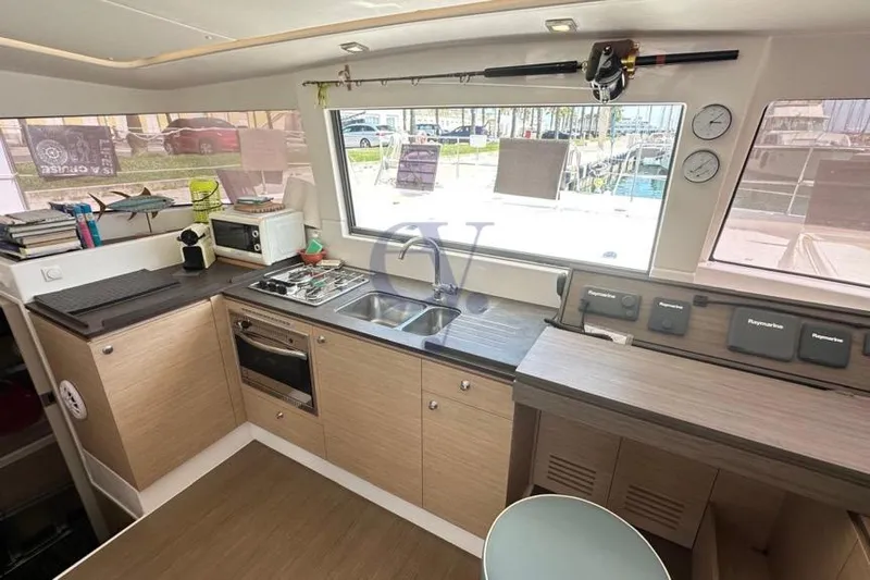  Yacht Photos Pics Interior of 2016 Catana Group Bali 4.0 yacht kitchen with modern appliances and large window.