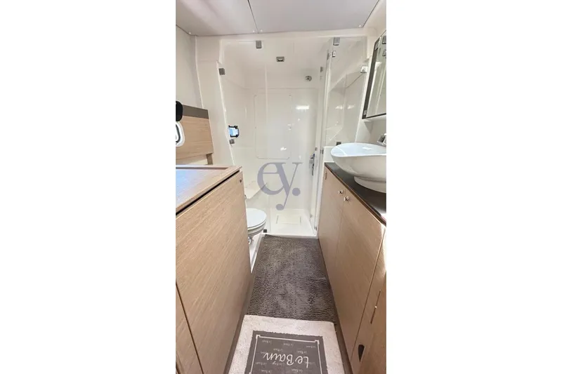  Yacht Photos Pics Bathroom interior of 2016 Catana Group Bali 4.0 yacht, featuring modern fixtures and wood cabinetry.