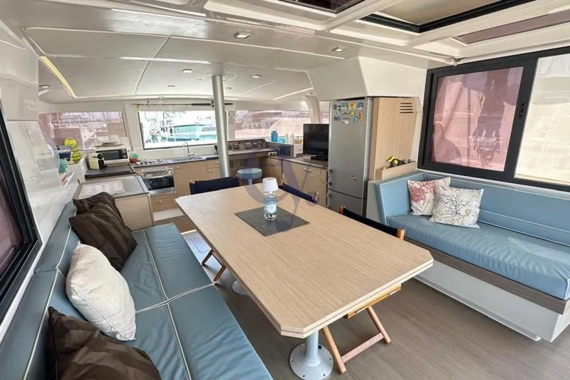  Yacht Photos Pics Interior of 2016 Catana Group Bali 4.0 catamaran with modern dining area and kitchen.