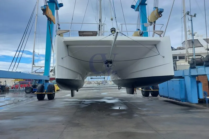  Yacht Photos Pics 2016 Catana Group Bali 4.0 catamaran in dry dock, lifted by blue crane.