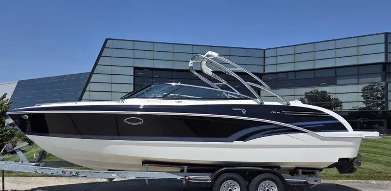  Yacht Photos Pics 2016 Formula 290 Bowrider boat on trailer, sleek design, parked near modern building.
