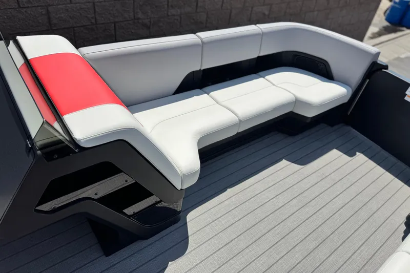  Yacht Photos Pics Luxurious seating on 2026 Manitou Explore Dual Engine boat, featuring sleek white and red upholstery.