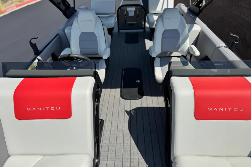  Yacht Photos Pics 2026 Manitou Explore Dual Engine boat interior with modern seating and sleek design.