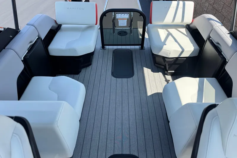  Yacht Photos Pics Interior of 2026 Manitou Explore Dual Engine boat with white seating and gray flooring.