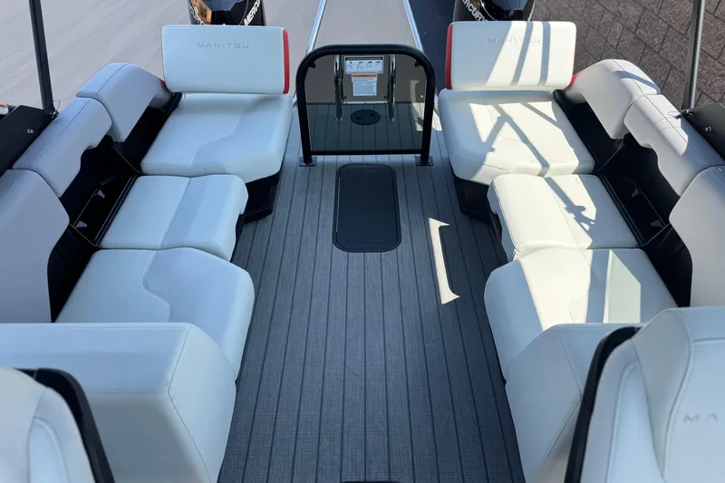  Yacht Photos Pics Luxurious interior of 2026 Manitou Explore Dual Engine boat with white seating.