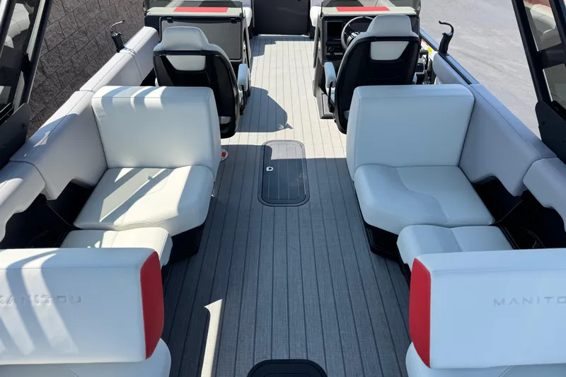  Yacht Photos Pics 2026 Manitou Explore Dual Engine boat interior with white seating and modern design.
