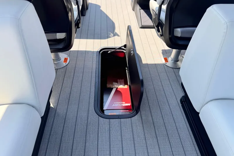  Yacht Photos Pics 2026 Manitou Explore Dual Engine boat interior with open storage compartment.