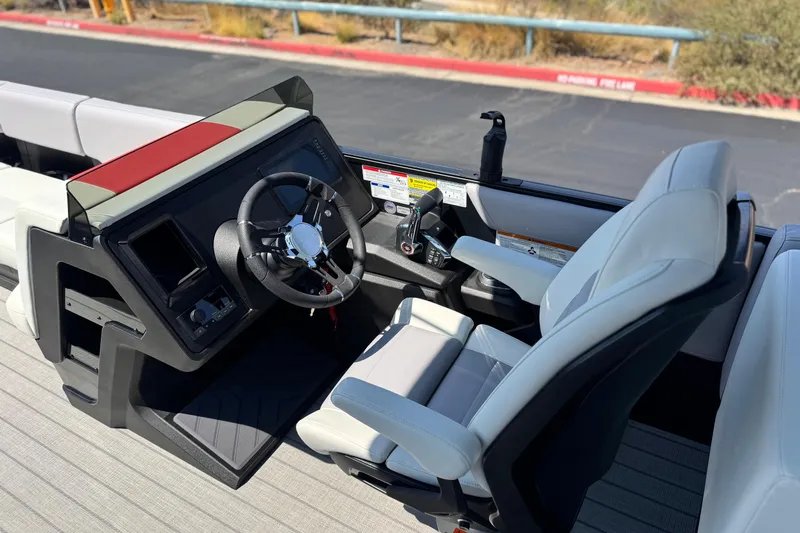  Yacht Photos Pics 2026 Manitou Explore Dual Engine boat cockpit with modern steering and controls.