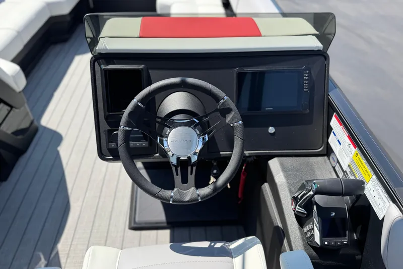  Yacht Photos Pics 2026 Manitou Explore Dual Engine boat dashboard with steering wheel and control panel.