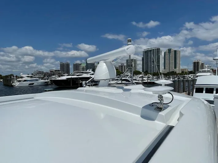  Yacht Photos Pics 2019 Cruisers 50 Cantius yacht docked in marina, city skyline in background.