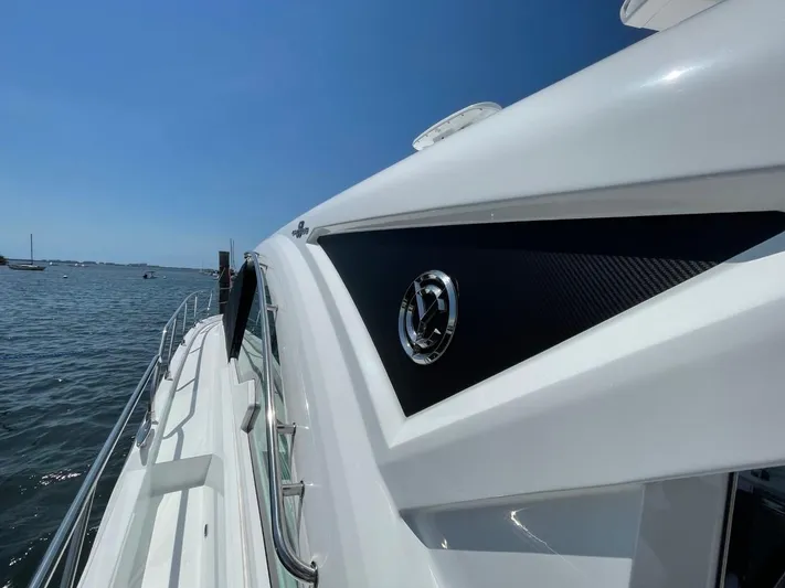  Yacht Photos Pics 2019 Cruisers 50 Cantius yacht side view on water, showcasing sleek design and logo.