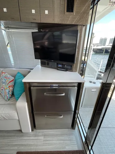  Yacht Photos Pics 2019 Cruisers 50 Cantius yacht interior with TV, stainless steel drawers, and waterfront view.