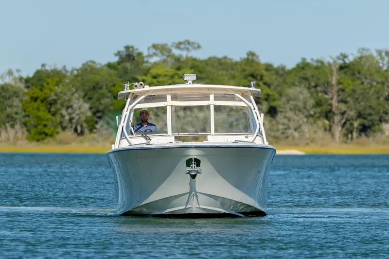  Yacht Photos Pics 2020 Grady-White Freedom 307 boat cruising on a serene lake.