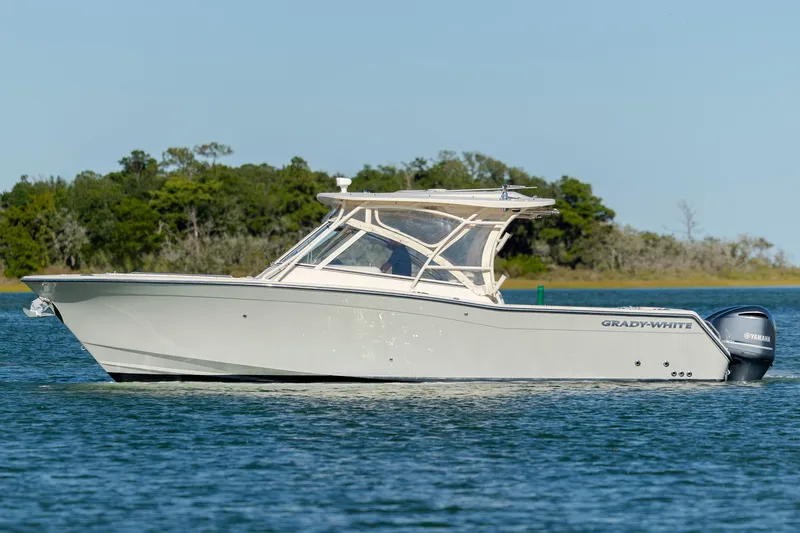  Yacht Photos Pics 2020 Grady-White Freedom 307 boat on calm water with scenic background.