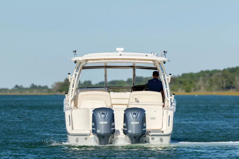  Yacht Photos Pics 2020 Grady-White Freedom 307 boat cruising on a calm lake.