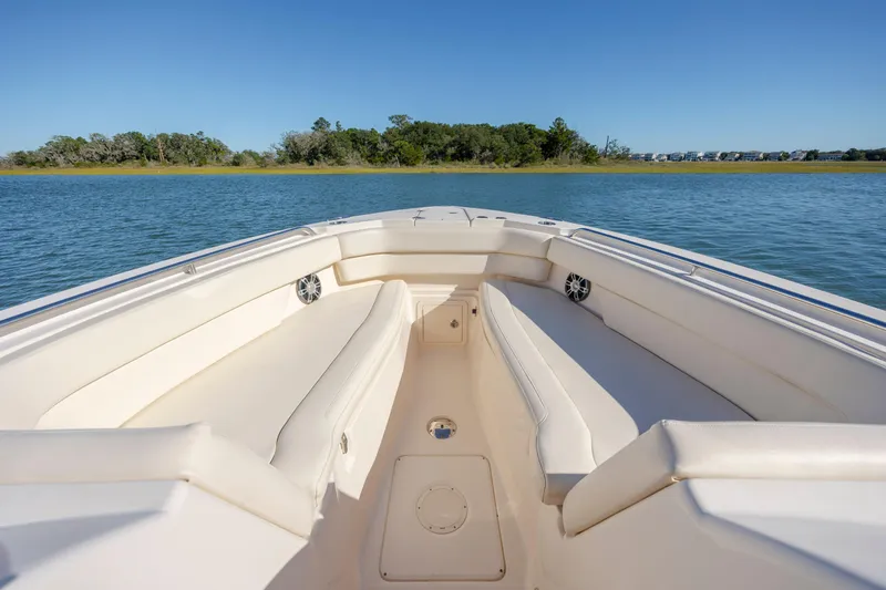  Yacht Photos Pics 2020 Grady-White Freedom 307 boat interior with spacious seating on calm water.