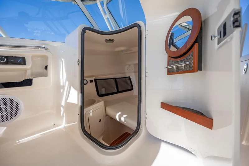  Yacht Photos Pics 2020 Grady-White Freedom 307 cabin interior with seating and storage.