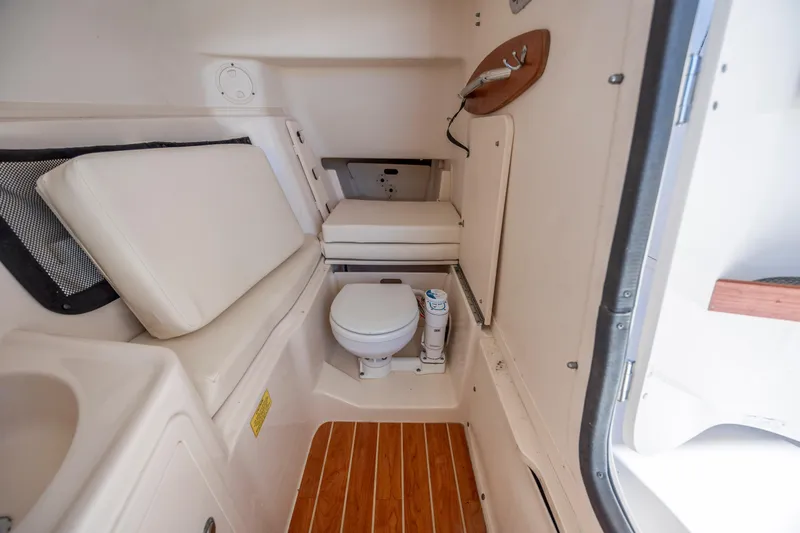  Yacht Photos Pics 2020 Grady-White Freedom 307 boat interior with toilet and seating area.