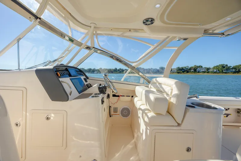  Yacht Photos Pics 2020 Grady-White Freedom 307 boat interior with helm, luxurious seating, and scenic water view.