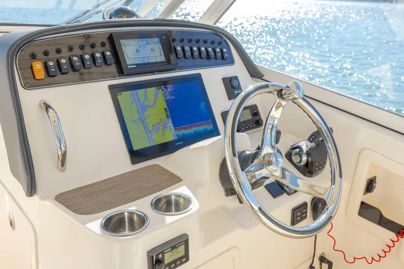  Yacht Photos Pics 2020 Grady-White Freedom 307 boat dashboard with navigation screens and steering wheel.