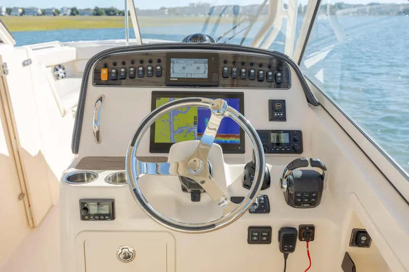  Yacht Photos Pics Grady-White Freedom 307 2020 boat dashboard with steering wheel and navigation controls.
