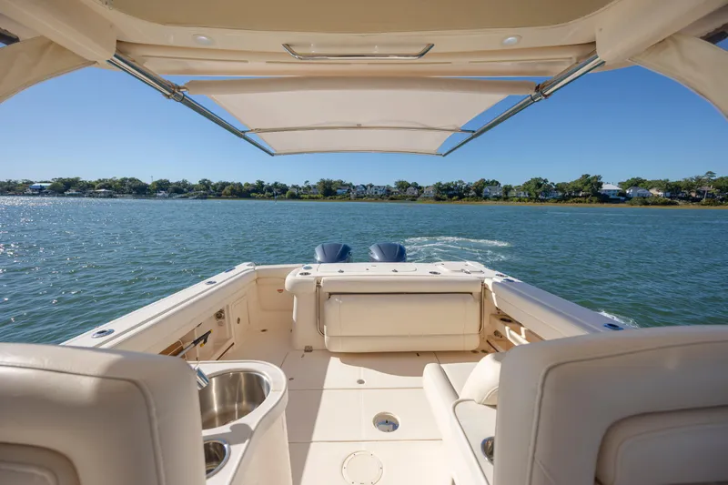  Yacht Photos Pics 2020 Grady-White Freedom 307 boat interior with canopy on a sunny day.